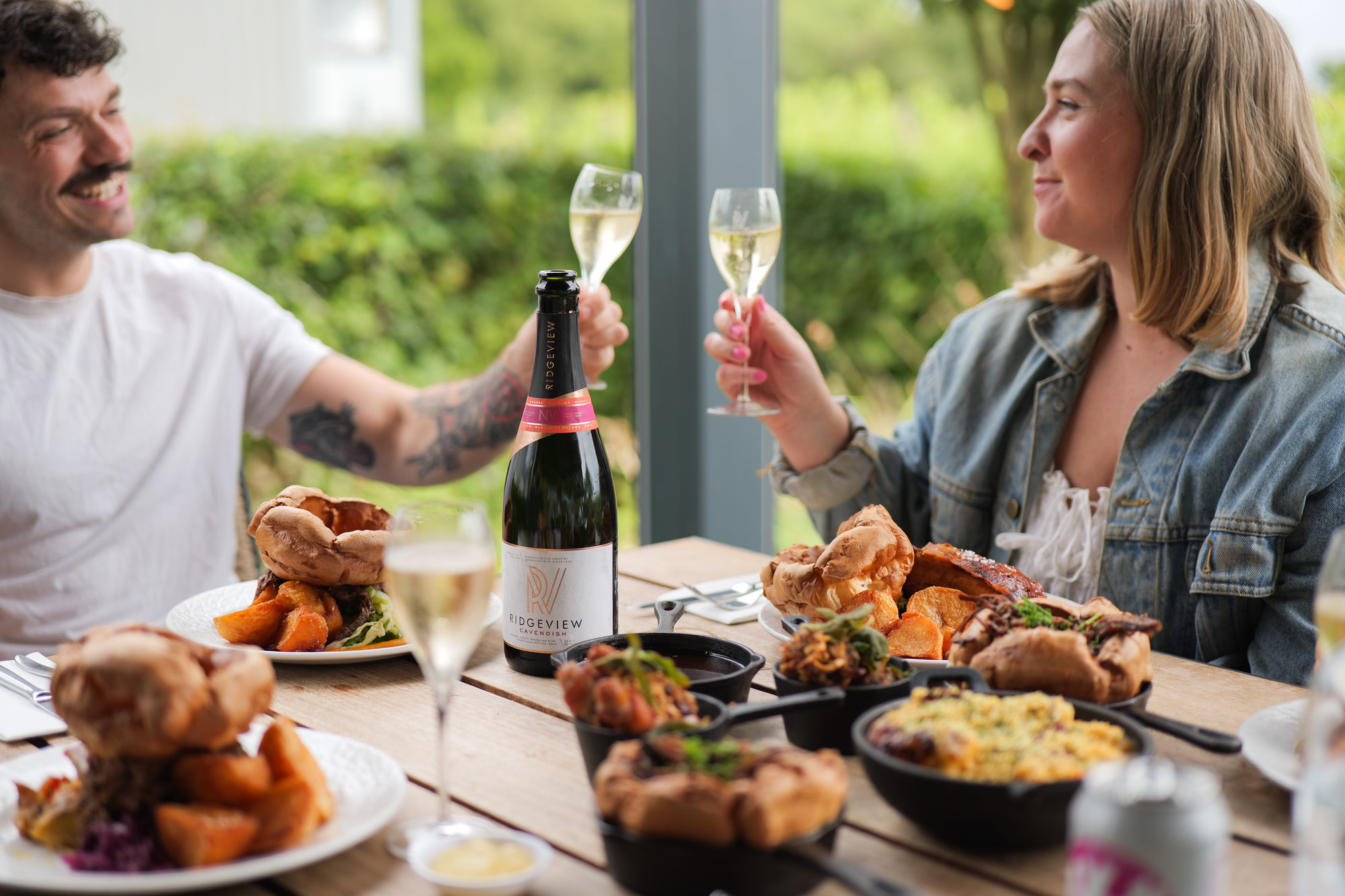 Man and woman drinking wine with roast at Rows and Vine